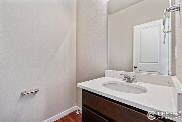 bathroom with hardwood / wood-style flooring and vanity