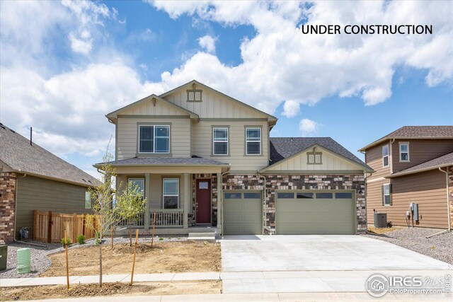 craftsman-style home featuring a porch, a garage, and central AC