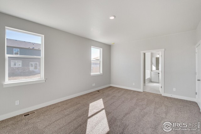 unfurnished room with light colored carpet