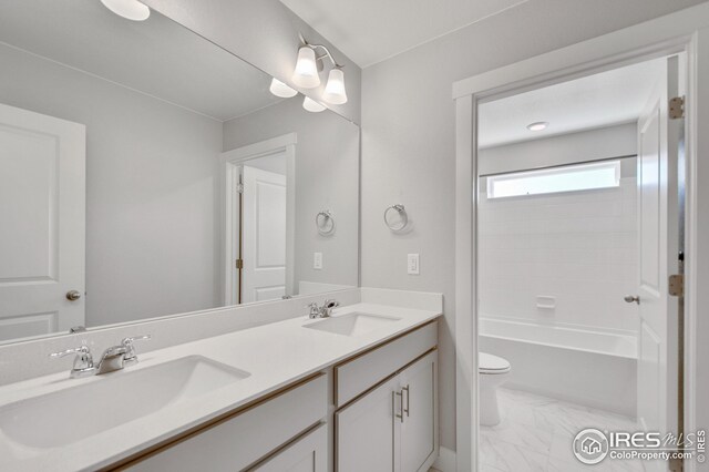 full bathroom with vanity, toilet, and washtub / shower combination