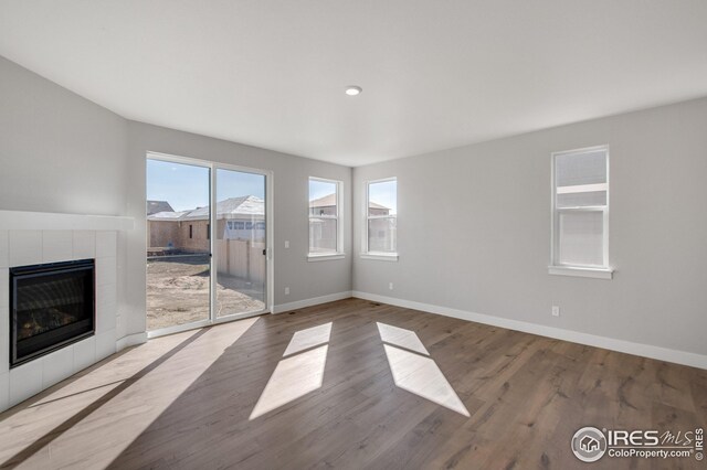 unfurnished living room with light hardwood / wood-style floors and a fireplace