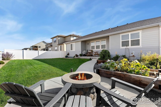 rear view of house featuring a patio and a lawn