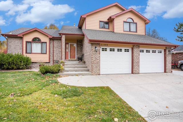 front of property with a front lawn and a garage