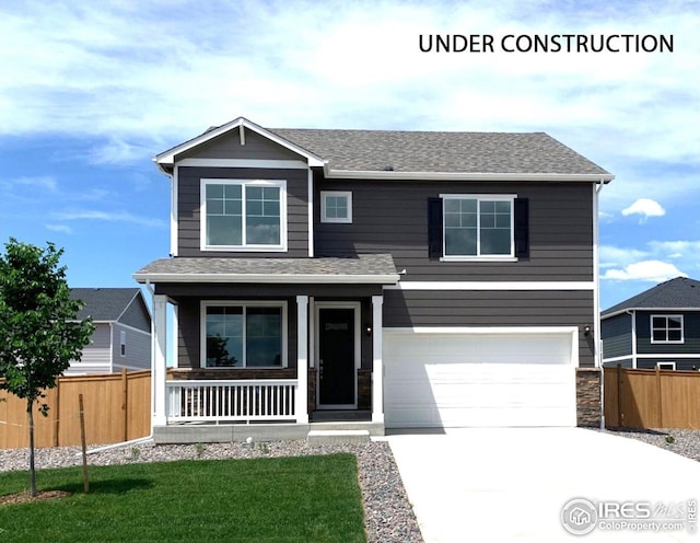 craftsman-style home featuring a front yard, a porch, and a garage