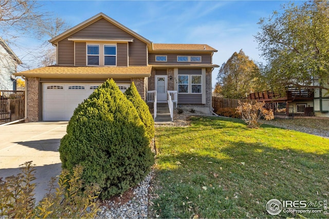 view of front of property with a garage and a front lawn