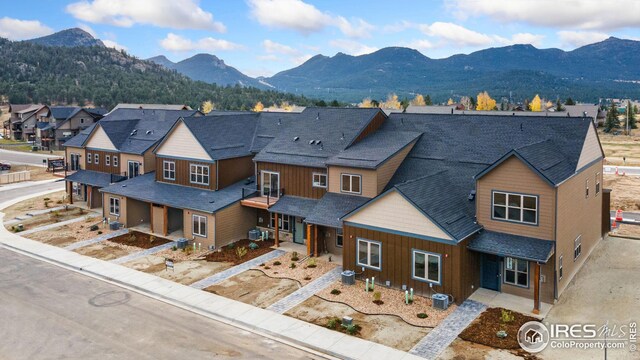 exterior space with a mountain view and central AC