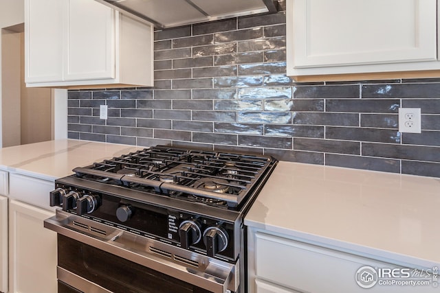 6105 Saddle Horn Dr, Timnath, CO 80547 - kitchen featuring range with two ovens, tasteful backsplash, white cabinets, and light stone counters