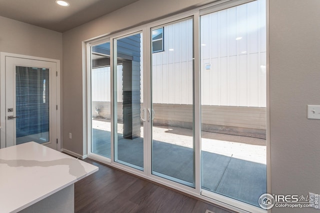 6105 Saddle Horn Dr, Timnath, CO 80547 - doorway with dark wood-type flooring and recessed lighting