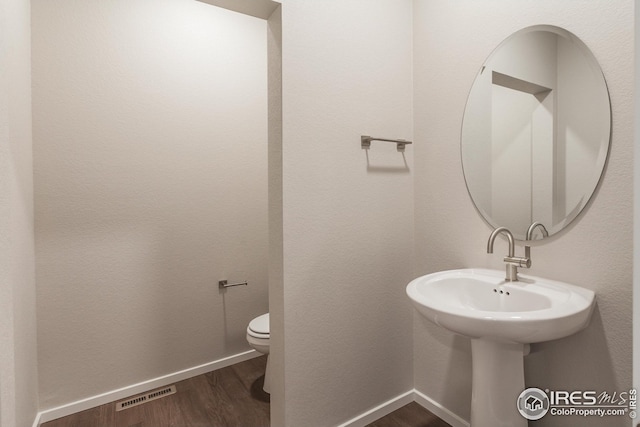 6105 Saddle Horn Dr, Timnath, CO 80547 - bathroom featuring wood finished floors, toilet, and baseboards