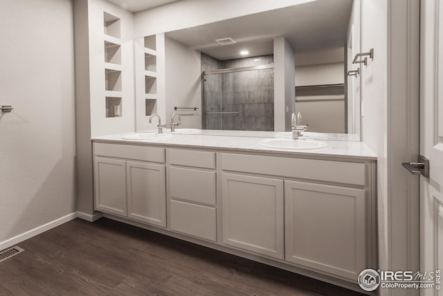 6105 Saddle Horn Dr, Timnath, CO 80547 - full bathroom with a shower stall, baseboards, wood finished floors, and double vanity