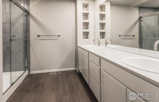 6105 Saddle Horn Dr, Timnath, CO 80547 - full bath featuring wood finished floors, a shower stall, baseboards, and double vanity