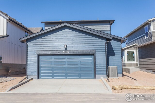 6105 Saddle Horn Dr, Timnath, CO 80547 - view of front of house with an attached garage, concrete driveway, and central AC unit