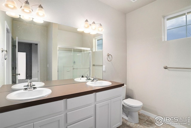 bathroom with toilet, vanity, tile patterned floors, and walk in shower