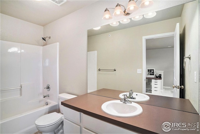 full bathroom featuring toilet, vanity, and tub / shower combination