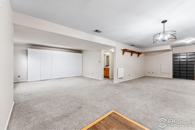 interior space featuring light carpet and an inviting chandelier