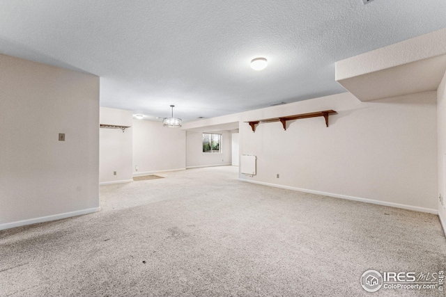 interior space featuring a textured ceiling and light colored carpet