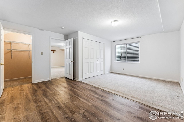 unfurnished bedroom featuring dark hardwood / wood-style floors and a textured ceiling