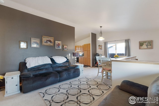 carpeted living room with lofted ceiling