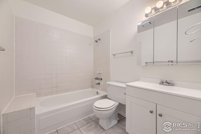 full bathroom featuring tile patterned flooring, vanity, toilet, and tiled shower / bath