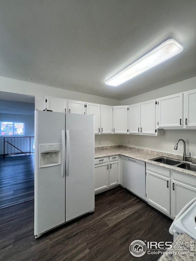 kitchen with sink, white cabinets, and white refrigerator with ice dispenser