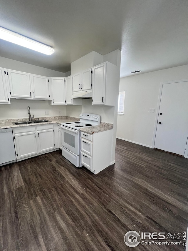 kitchen with white cabinets, white appliances, dark hardwood / wood-style floors, and sink