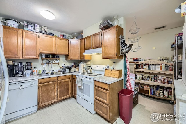 kitchen featuring sink and white appliances