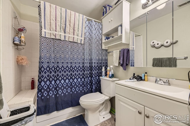 bathroom featuring tile patterned flooring, vanity, toilet, and walk in shower