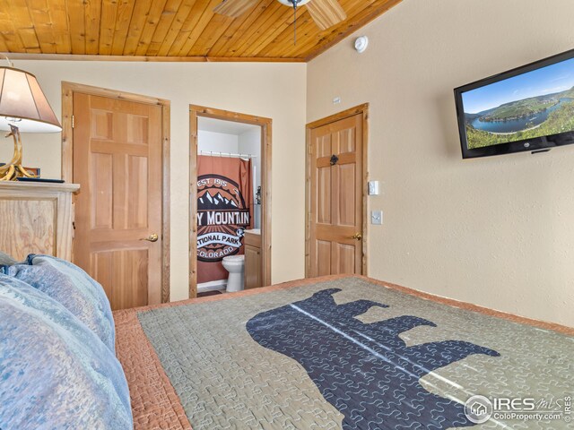 bedroom with connected bathroom, wooden ceiling, and lofted ceiling