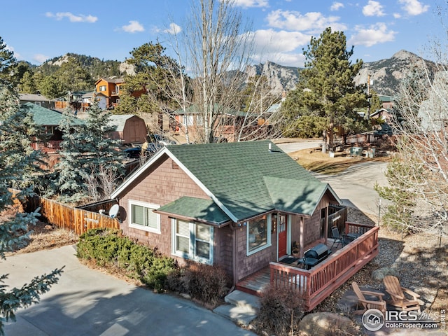 exterior space with a deck with mountain view