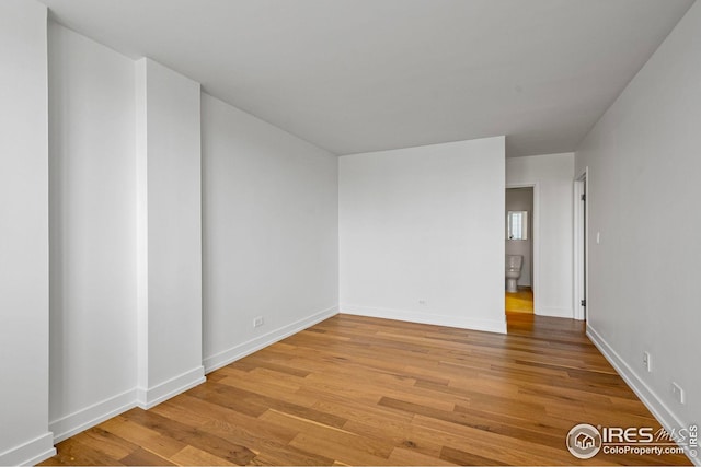 unfurnished room with light wood-type flooring