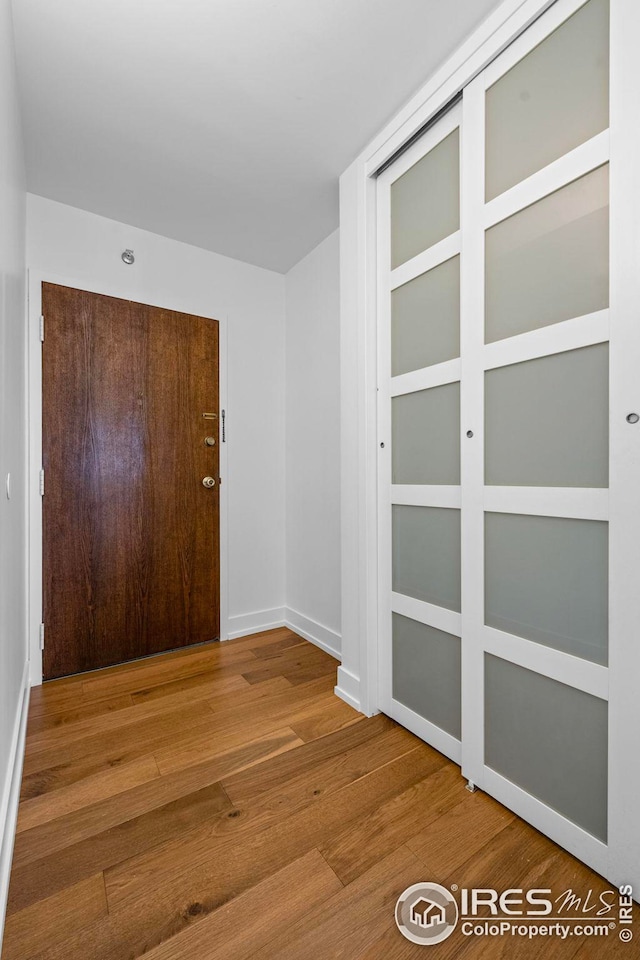 corridor featuring hardwood / wood-style floors