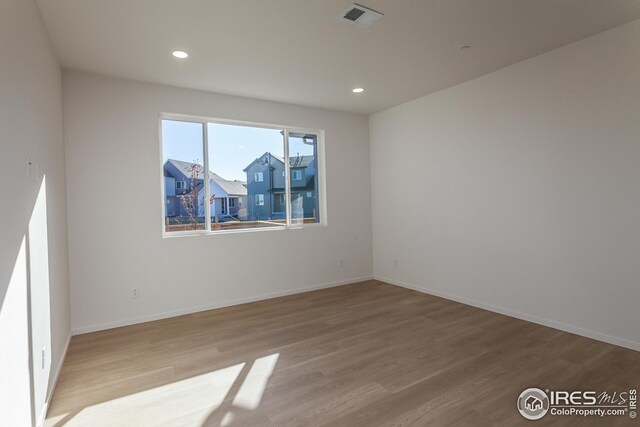 spare room with light hardwood / wood-style flooring