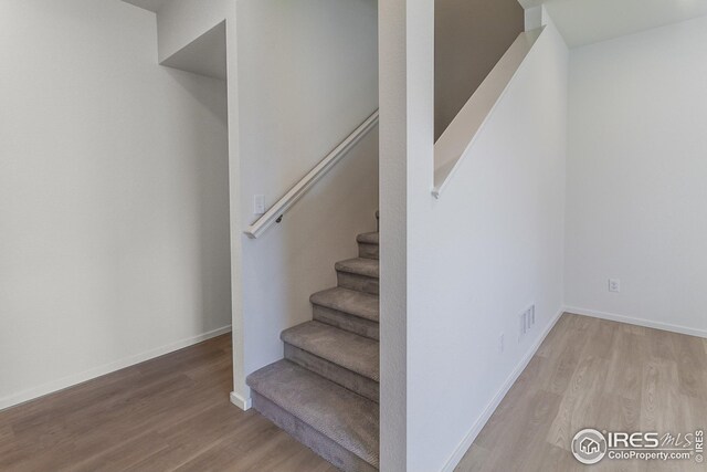 staircase featuring hardwood / wood-style floors