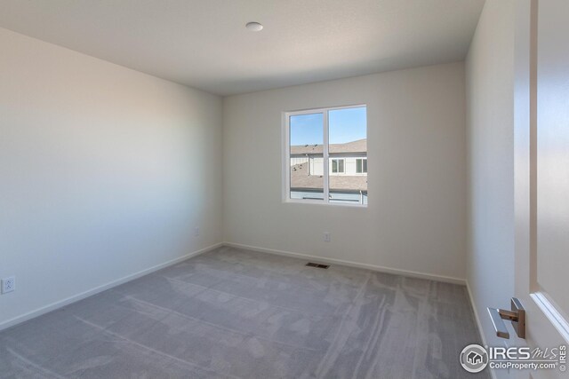 empty room with dark colored carpet