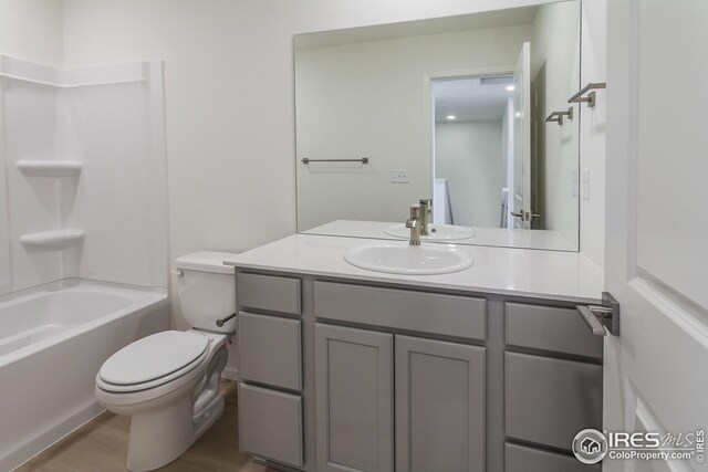 full bathroom with vanity, toilet, and  shower combination