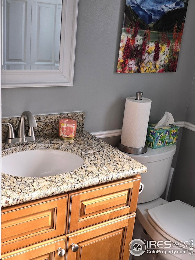 bathroom featuring vanity and toilet