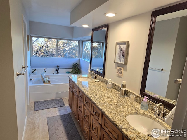 bathroom with tile patterned floors, vanity, and a washtub