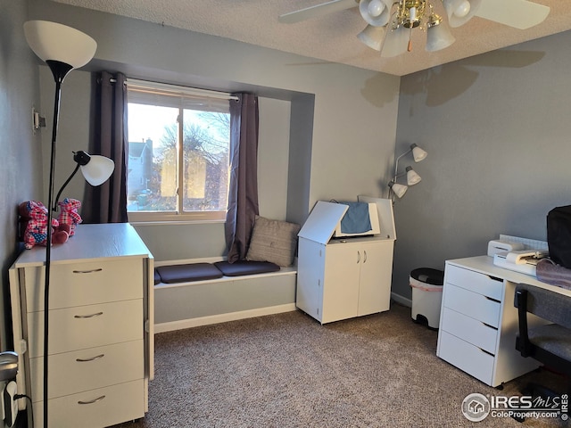 carpeted home office featuring ceiling fan and a textured ceiling