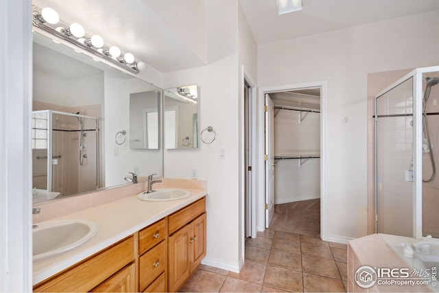 bathroom featuring vanity, tile patterned floors, and a shower with shower door