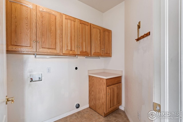 washroom with cabinets, hookup for a washing machine, hookup for an electric dryer, and light tile patterned floors