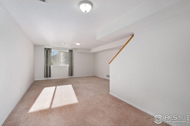 unfurnished room with light colored carpet