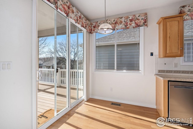 unfurnished dining area with light wood-type flooring