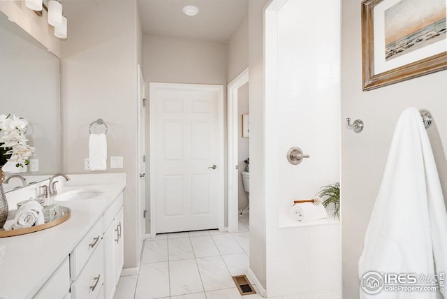 bathroom featuring tile patterned floors, toilet, and vanity