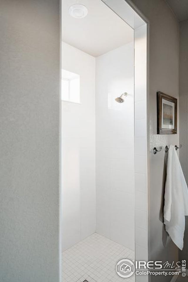 bathroom with tiled shower