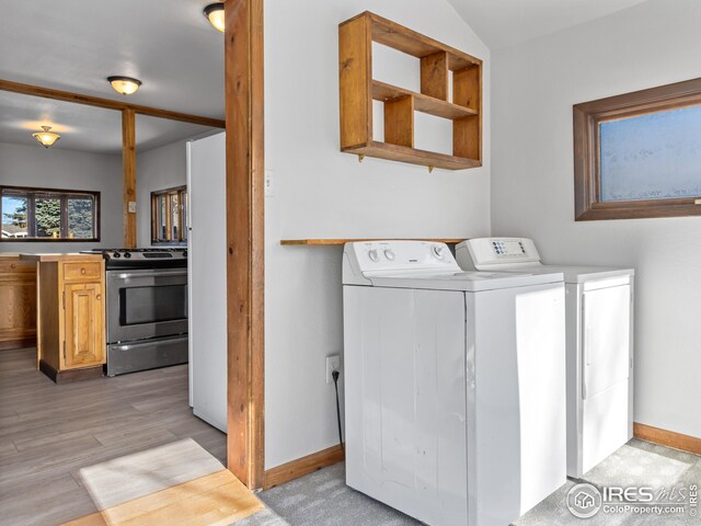 laundry area featuring washer and dryer and light wood-type flooring