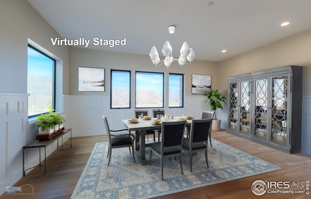 dining space with recessed lighting, a chandelier, wood finished floors, and wainscoting