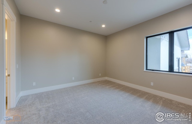 carpeted spare room with recessed lighting and baseboards