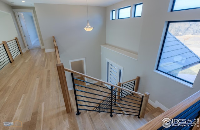 stairs with recessed lighting, baseboards, and wood finished floors