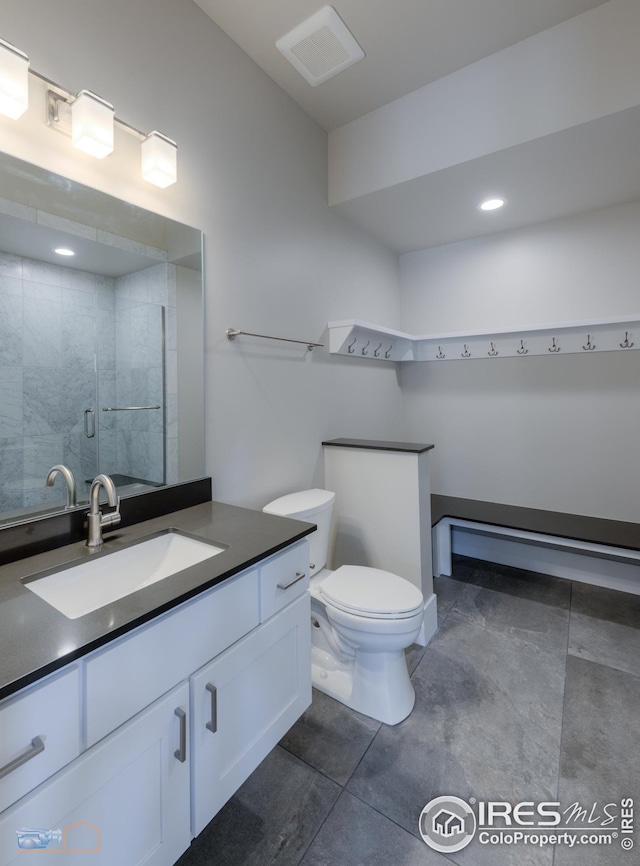 bathroom featuring vanity, visible vents, a stall shower, tile patterned flooring, and toilet