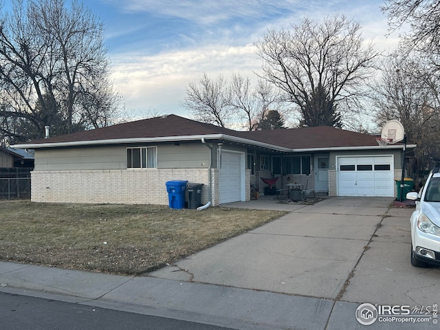 single story home with a garage and a front lawn